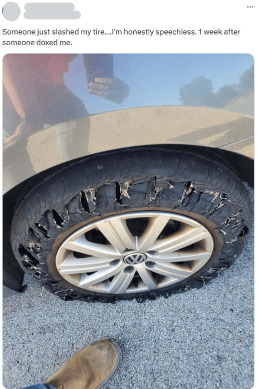 X/twitter post and photo of a slashed tire after getting doxxed 