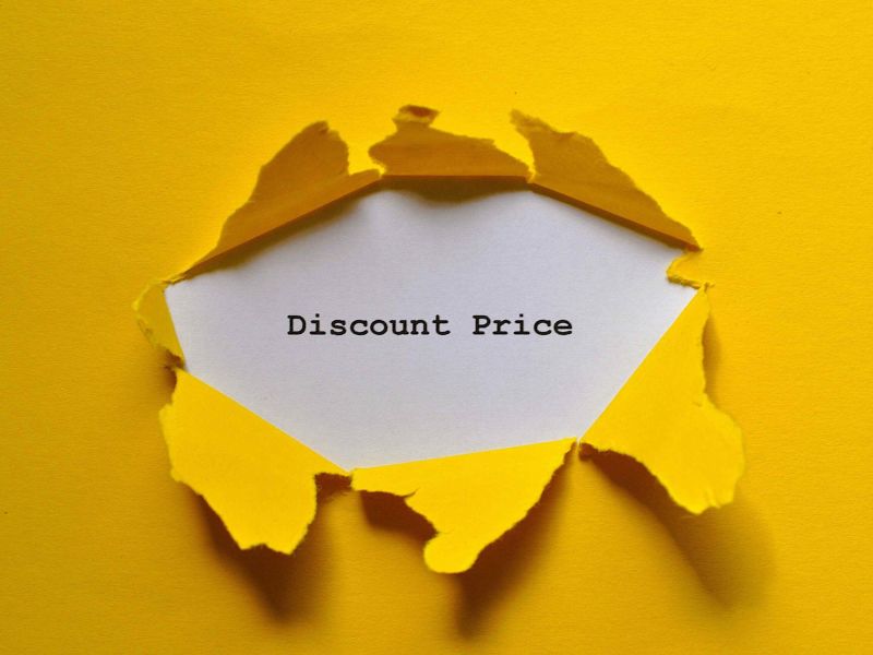 Discount price behind torn yellow paper, indicating fictitious pricing