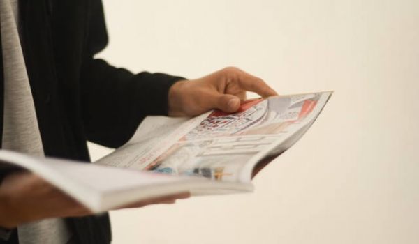 person holding a magazine in their hands