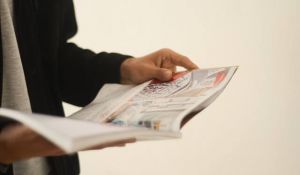 person holding a magazine in their hands